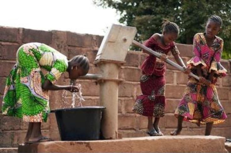 Drilling a well with a hand pump in the remote village of Wardi in Togo