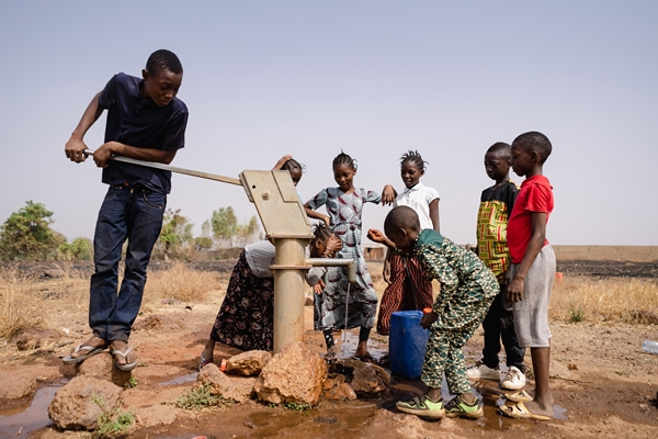 A hand-pumped well drilling project in a newly converted village in Sierra Leone